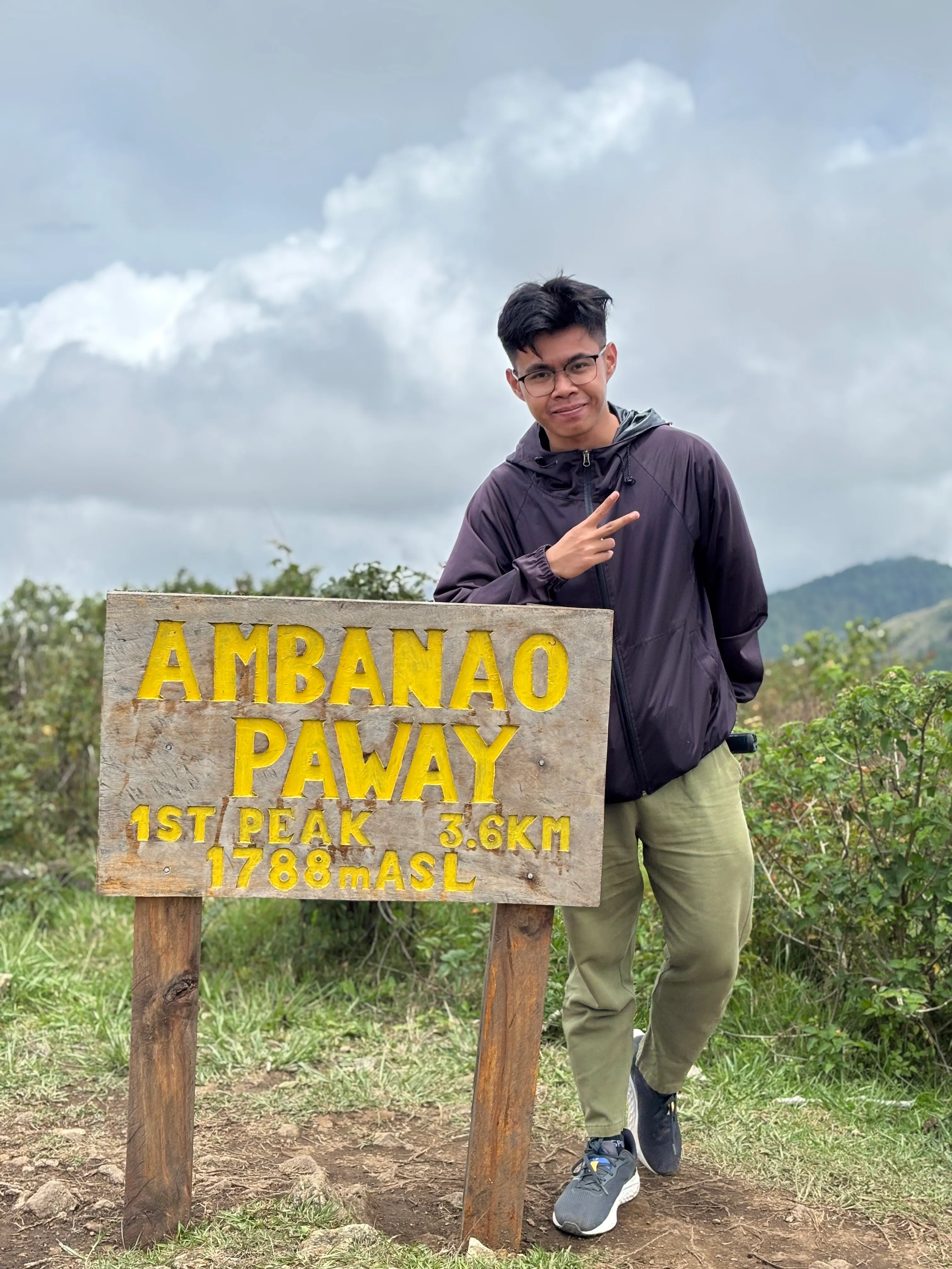 Ericson beside the Ambanao Paway summit sign, 1,788 metres above sea level