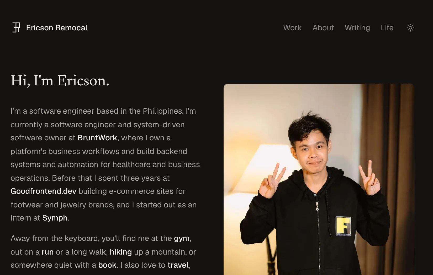 The homepage of this site in dark mode, with the introduction on the left and a portrait photo on the right