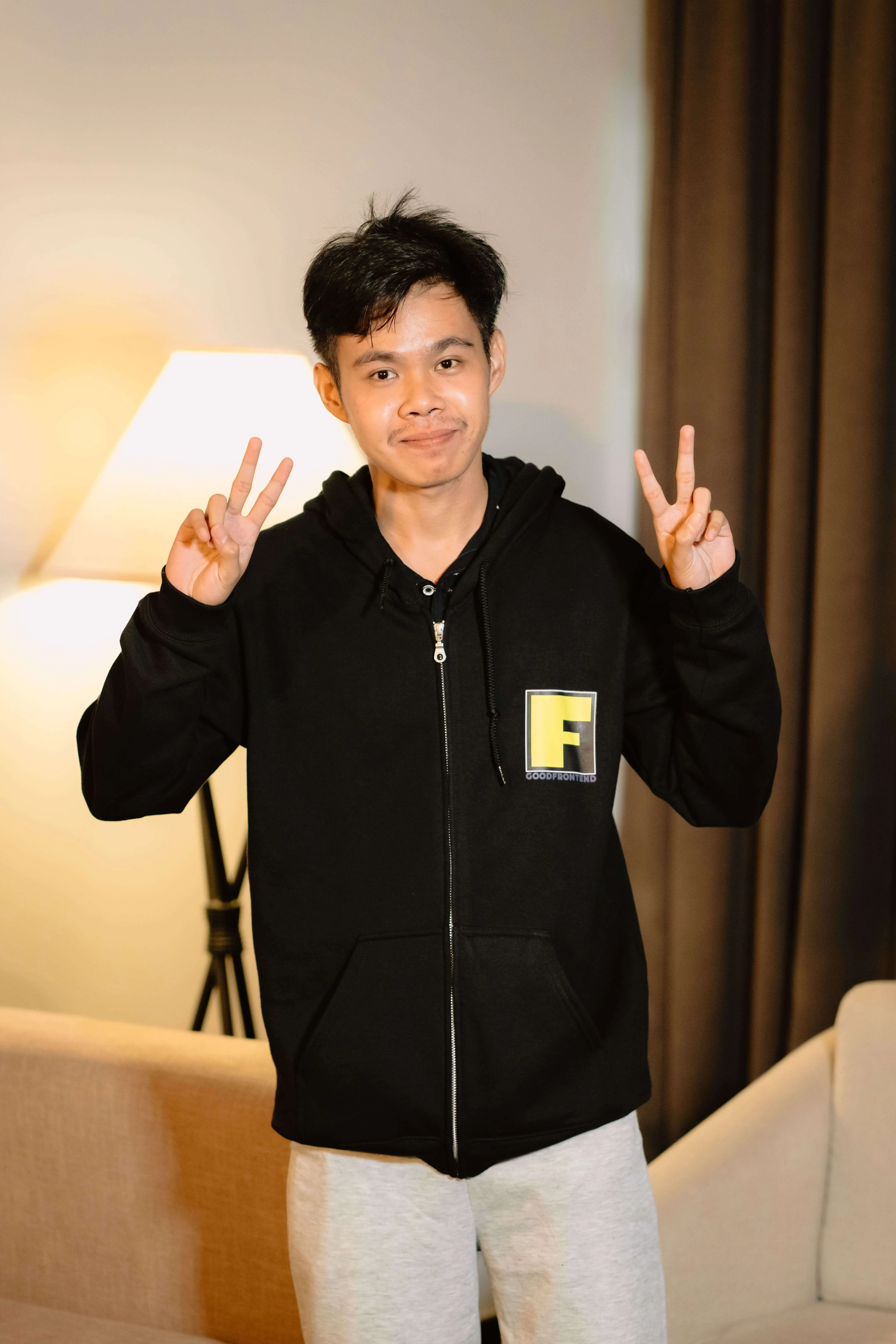 Ericson smiling and holding up peace signs